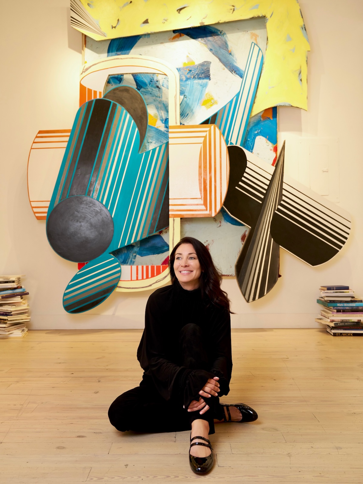 Anna Forré, Owner, Gallerist, and Art Advisor in Aspen in front of a Frank Stella piece in Forré Gallery.