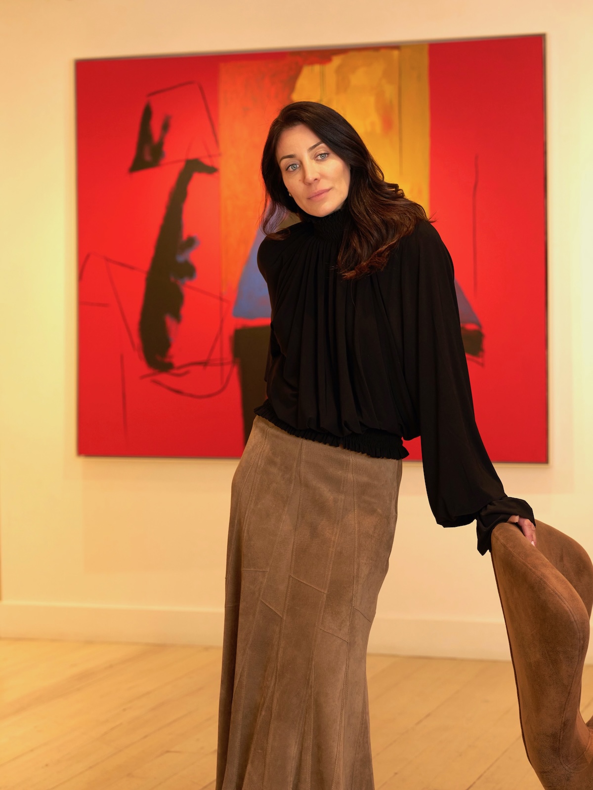Anna Forré, owner and gallerist at Forré Fine Arts, in front of a red Robert Motherwell painting at Forré Fine Arts Gallery in Aspen.